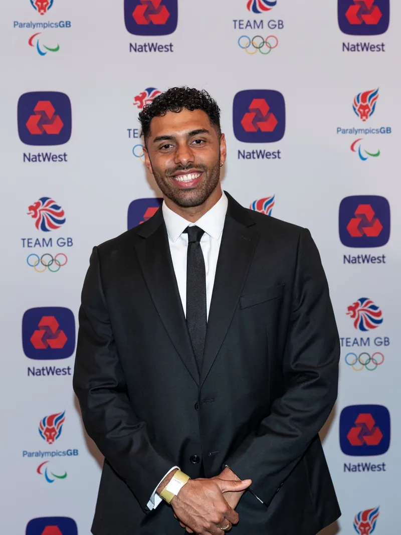 Portrait of Leon Greenwood in a dark suit at a Team GB event